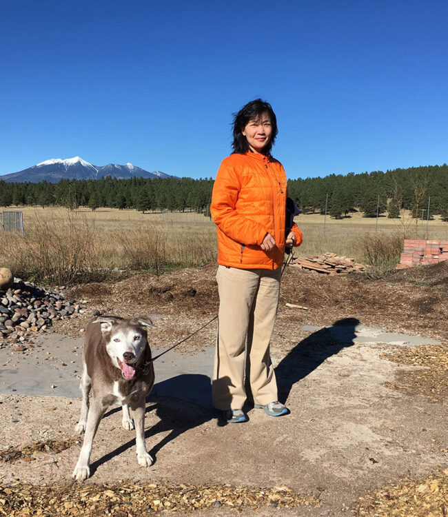 Photo of Kun-Yen Kuo and dog out on a hike.